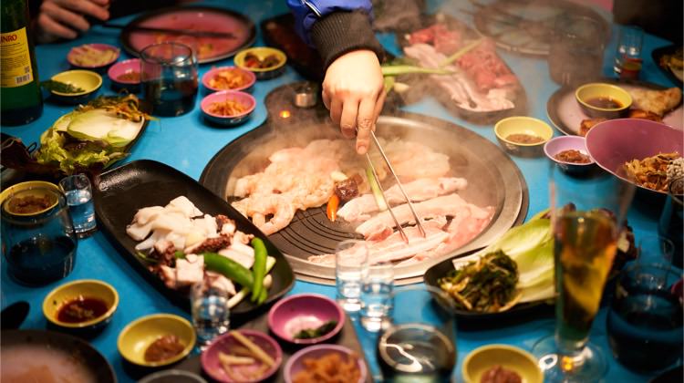 Food on the in-table grill at Gunbae Korean BBQ.