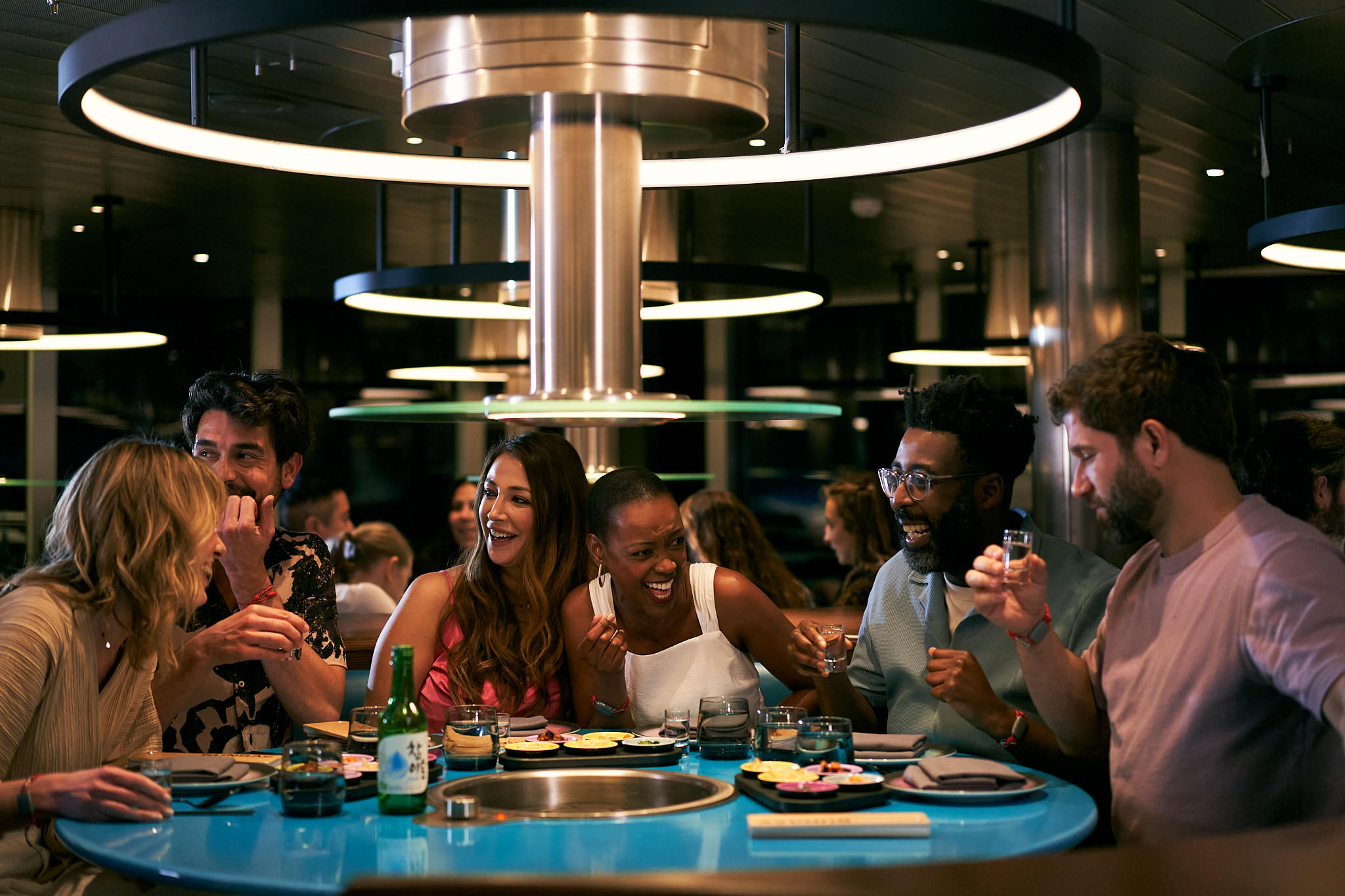 A group enjoys Korean BBQ at Gunbae restaurant.